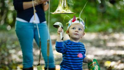Toddler playing in a forest